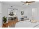 Stylish bedroom featuring a ceiling fan, closet with mirror, and an accent chair at 7615 E Quincy Ave # 103, Denver, CO 80237