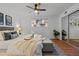 Bright bedroom with a ceiling fan, wood floors, closet, and large window providing ample light at 7615 E Quincy Ave # 103, Denver, CO 80237