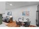 Cozy dining area features a round table and views into the living room at 7615 E Quincy Ave # 103, Denver, CO 80237
