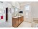 Bathroom with double vanity, large mirror, and neutral tile at 2200 S University Blvd # 514, Denver, CO 80210