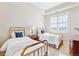 Bright bedroom with two twin beds and window with plantation shutters at 2200 S University Blvd # 514, Denver, CO 80210