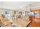 Spacious dining room with a long wood table and a view of the living area and outdoor space at 2200 S University Blvd # 514, Denver, CO 80210