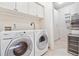 Efficient laundry area with a wine fridge, washer, and dryer at 2200 S University Blvd # 514, Denver, CO 80210