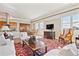Open-concept living room with hardwood floors, large windows, and a cozy seating area at 2200 S University Blvd # 514, Denver, CO 80210