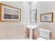Charming powder room with pedestal sink and decorative wallpaper at 2200 S University Blvd # 514, Denver, CO 80210