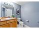 Clean and well-maintained half bathroom with light wood vanity at 4875 S Monaco St # 107, Denver, CO 80237