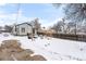 Snowy backyard with patio and seating area at 5454 Clay St, Denver, CO 80221