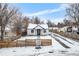 Newly renovated home with snow covered yard at 5454 Clay St, Denver, CO 80221