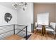 Modern staircase with metal railing overlooking a dining area at 5454 Clay St, Denver, CO 80221