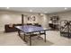 Finished basement with ping pong table, sofa, shelving, and desk perfect for recreation and hobbies at 7836 S Fairfax Ct, Centennial, CO 80122