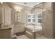 Luxurious bathroom features a tub, stand-up shower, double vanity, and plenty of natural light at 7836 S Fairfax Ct, Centennial, CO 80122