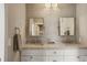 Modern bathroom boasts dual sinks, marble countertops, and trendy lighting fixtures and mosaic tiled accent wall at 7836 S Fairfax Ct, Centennial, CO 80122
