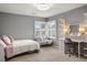 Cozy bedroom featuring neutral colors, a desk and vanity area, and a plush bed with plentiful natural light at 7836 S Fairfax Ct, Centennial, CO 80122