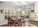 Dining room features a wooden table with bench seating, shuttered windows, and access to the outdoor patio at 7836 S Fairfax Ct, Centennial, CO 80122