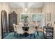 Formal dining room with stylish furniture, large windows with shutters, and a decorative chandelier at 7836 S Fairfax Ct, Centennial, CO 80122