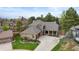 Stunning home exterior with brick accents, mature trees, and a well-manicured front yard at 7836 S Fairfax Ct, Centennial, CO 80122