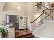 Grand foyer with hardwood floors, a sweeping staircase, elegant lighting, and a welcoming entrance at 7836 S Fairfax Ct, Centennial, CO 80122