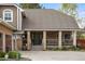 Inviting front porch featuring stone columns, and mature landscaping in a classic, well-maintained residence at 7836 S Fairfax Ct, Centennial, CO 80122