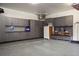 Organized garage with custom cabinets and epoxy floors provides ample storage space for vehicles and equipment at 7836 S Fairfax Ct, Centennial, CO 80122