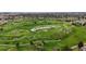 Picturesque aerial view of a lush golf course with ponds, trees, and rolling fairways at 7836 S Fairfax Ct, Centennial, CO 80122
