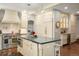Gourmet kitchen with modern stainless steel appliances, custom cabinetry, and a center island with seating at 7836 S Fairfax Ct, Centennial, CO 80122