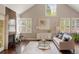 Bright living room with vaulted ceiling, fireplace, hardwood floors, and ample natural light at 7836 S Fairfax Ct, Centennial, CO 80122