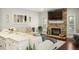 Bright living room with stone fireplace, wooden floors, and comfortable seating provides a relaxing atmosphere at 7836 S Fairfax Ct, Centennial, CO 80122