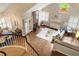 Spacious living room featuring hardwood floors, fireplace, and an open layout with abundant natural light at 7836 S Fairfax Ct, Centennial, CO 80122