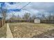 Spacious backyard featuring a storage shed and a wooden fence at 3640 Elm St, Denver, CO 80207