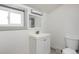 Bathroom featuring a single vanity, window, and toilet at 3640 Elm St, Denver, CO 80207