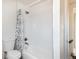 Bathroom featuring a shower-tub combo and a shower curtain at 3640 Elm St, Denver, CO 80207