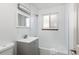 Bathroom featuring a shower-tub combo and a modern sink with a gray cabinet at 3640 Elm St, Denver, CO 80207