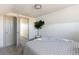 Bedroom with neutral gray carpet with an open door and green leafy plant at 3640 Elm St, Denver, CO 80207