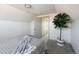 Bedroom with neutral gray carpet with an open door and green leafy plant at 3640 Elm St, Denver, CO 80207