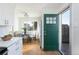 Dining area featuring a modern table set and a green door leading to the outside at 3640 Elm St, Denver, CO 80207