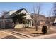 Charming two-story home with a mix of brick and siding, complemented by mature trees and a well-kept lawn at 3640 Elm St, Denver, CO 80207