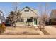 Light green two-story home with an inviting front exterior and walkway surrounded by bare trees at 3640 Elm St, Denver, CO 80207