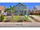 Charming two-story home with a green exterior, well-maintained lawn, and inviting front entrance at 3640 Elm St, Denver, CO 80207