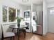 Bright kitchen nook with stainless steel refrigerator and stackable washer and dryer adjacent to a window at 3640 Elm St, Denver, CO 80207