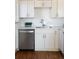 Modern kitchen design with stainless steel dishwasher, white cabinetry and granite countertops at 3640 Elm St, Denver, CO 80207