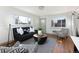 Cozy living room featuring wood floors, large windows, and modern black furniture at 3640 Elm St, Denver, CO 80207