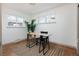 Light-filled office with a black chair, stylish rug, and natural light from two windows at 3640 Elm St, Denver, CO 80207