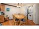 Cozy dining room with wood floors, ceiling fan, seating for six and convenient laundry closet at 12151 Melody Dr # 202, Westminster, CO 80234