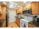Well-lit kitchen featuring stainless steel appliances, granite countertops, and light wood cabinets at 12151 Melody Dr # 202, Westminster, CO 80234
