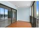 Enclosed sunroom with a glass sliding door and balcony with black railings that offer pleasant views of the city at 7877 E Mississippi Ave # 1107, Denver, CO 80247