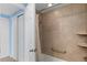 Tiled bathroom with shower and tub combination with safety grab bar at 7877 E Mississippi Ave # 1107, Denver, CO 80247