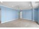 Spacious bedroom with plush carpeting, blue walls, and a ceiling fan at 7877 E Mississippi Ave # 1107, Denver, CO 80247