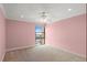 A carpeted bedroom with a ceiling fan and a large window with mountain views at 7877 E Mississippi Ave # 1107, Denver, CO 80247