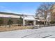 Exterior shot of the community clubhouse office with signage on a partly cloudy day and snow on the ground at 7877 E Mississippi Ave # 1107, Denver, CO 80247