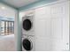 Stacked washer and dryer unit tucked away in a closet adding convenience to the living space at 7877 E Mississippi Ave # 1107, Denver, CO 80247